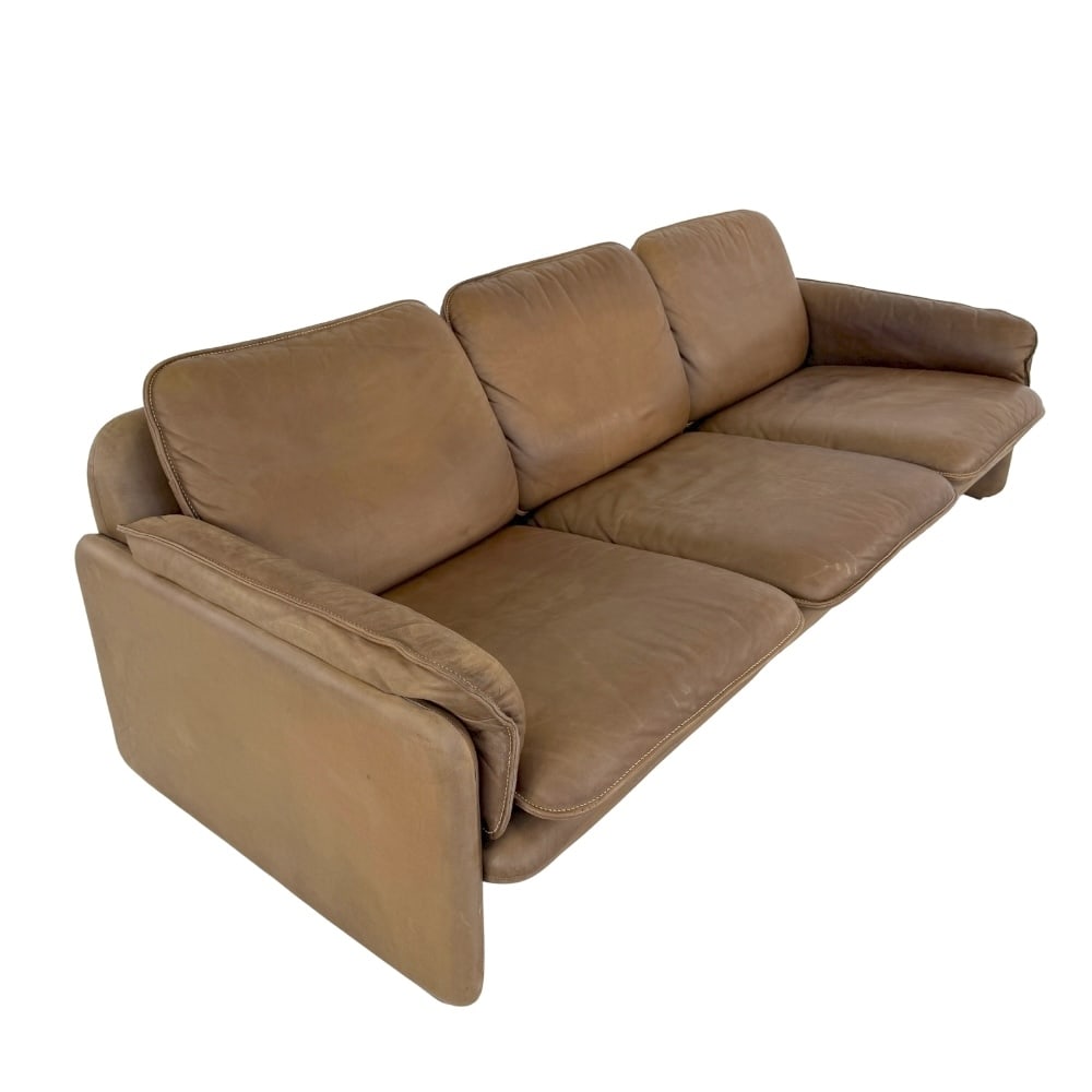 DE SEDE DS61 LEATHER THREE-SEAT SOFA, 1960s: Dimensions: H 27.5” x W 79” x D 34” x SH 16". De Sede DS61 brown leather three-seat sofa with removable cushions.