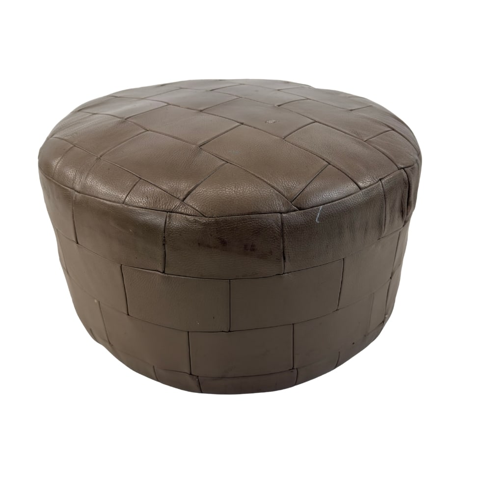 DE SEDE LEATHER POUF: Dimensions: H 14” x W 22”. Vintage De Sede leather patchwork pouf.