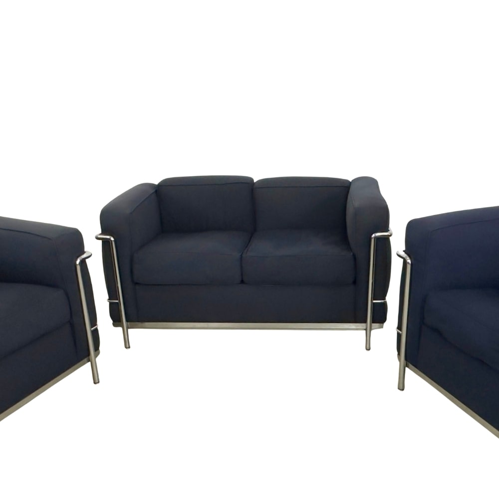 CASSINA LE CORBUSIER TWO-SEATER SOFA: Dimensions: H 26.5” x W 50.3” x D 26.5” x SH 18”. Pair of Cassina Le Corbusier LC 2 two-seater sofa in dark blue fabric and polished chrome frame. Stamped