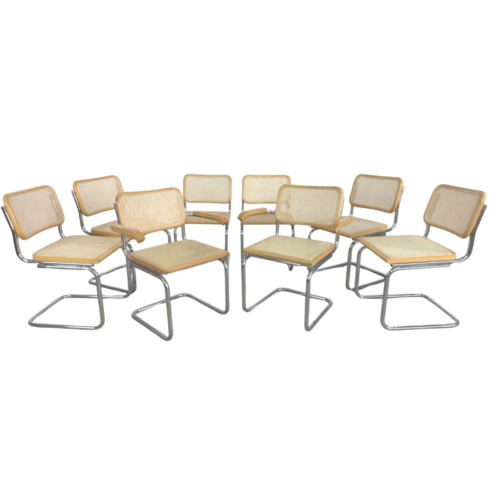 (8) CESCA CHAIRS BY MARCEL BREUER: Dimensions: H 32” x W 25.7” x SD 17” x SH 18”. Set of 8 dining chairs Cesca by Marcel Breuer with cane seats and tubular frame. Two of the chairs are with armrests.