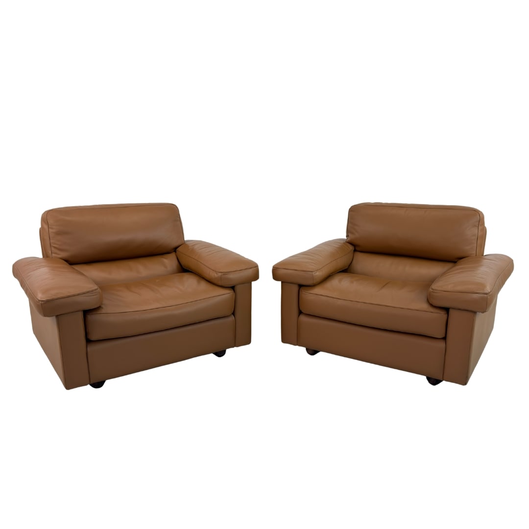 ARMCHAIRS BY TITO AGNOLI FOR POLTRONA FRAU, A PAIR: Dimensions: H 33” x W 45” x D 28” x SH 17”. Pair of Petronio brown leather armchairs, designed by Tito Agnoli for Polotrona Frau. As new condition