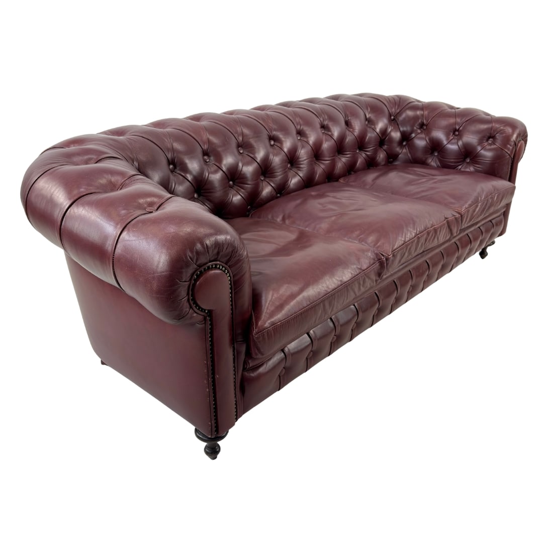 CHESTERFIELD 3-SEATER LEATHER SOFA: Dimensions: H 28” x W 78” x D 34” x SH 17.5”. Vintage Chesterfield burgundy leather three-seater sofa with loose padded cushions.