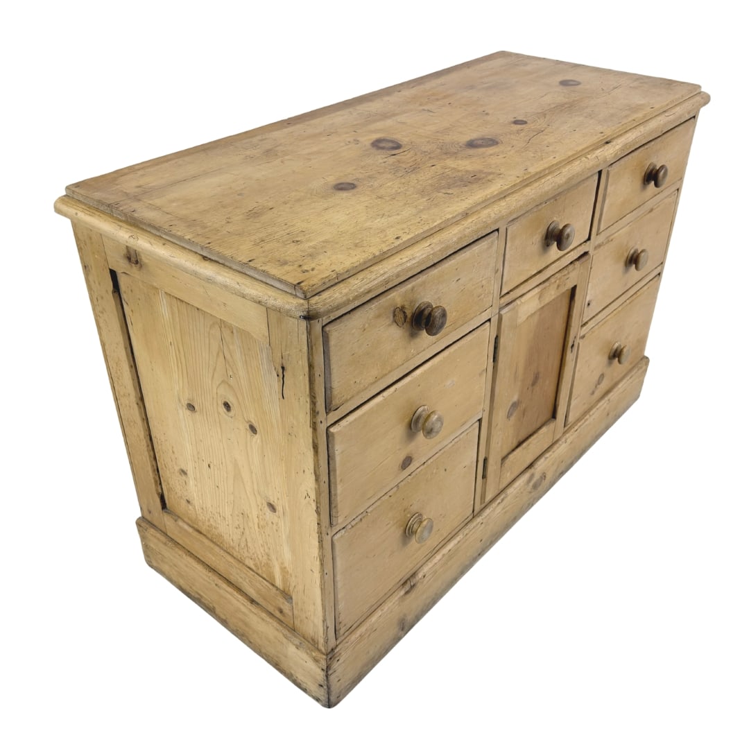 FRENCH PINE SIDEBOARD: Dimensions: H 33.3” x W 50.3” x D 21”. French pine sideboard with 7 drawers and one central cupboard.