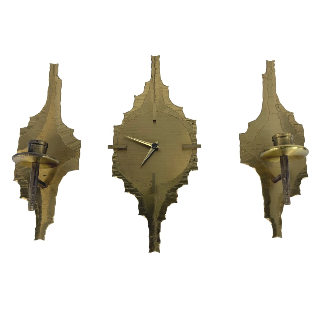 BRUTALIST WALL CLOCK AND HOLDERS BY K. B. NAUMBURG: Dimensions: H 12.5” x W 4”. Rare Brutalist handmade brass wall clock and pair of candle holders by K. B. Naumburg. Dimensions (candle holder) H 12.5" x W 5.3".