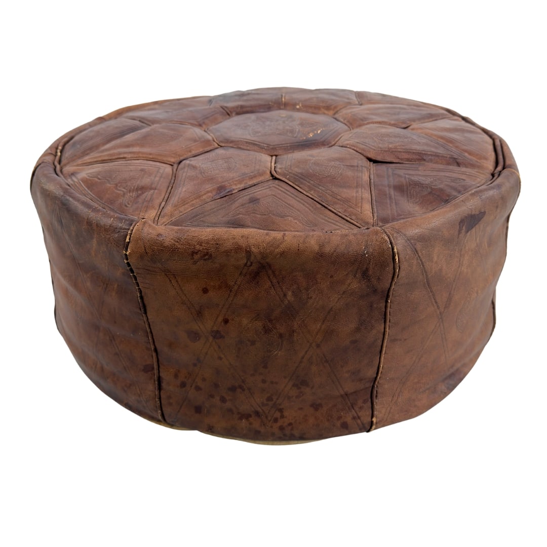 VINTAGE MOROCCAN POUF: Dimensions: H 9” x W 18.5”. Vintage Moroccan brown leather pouf.