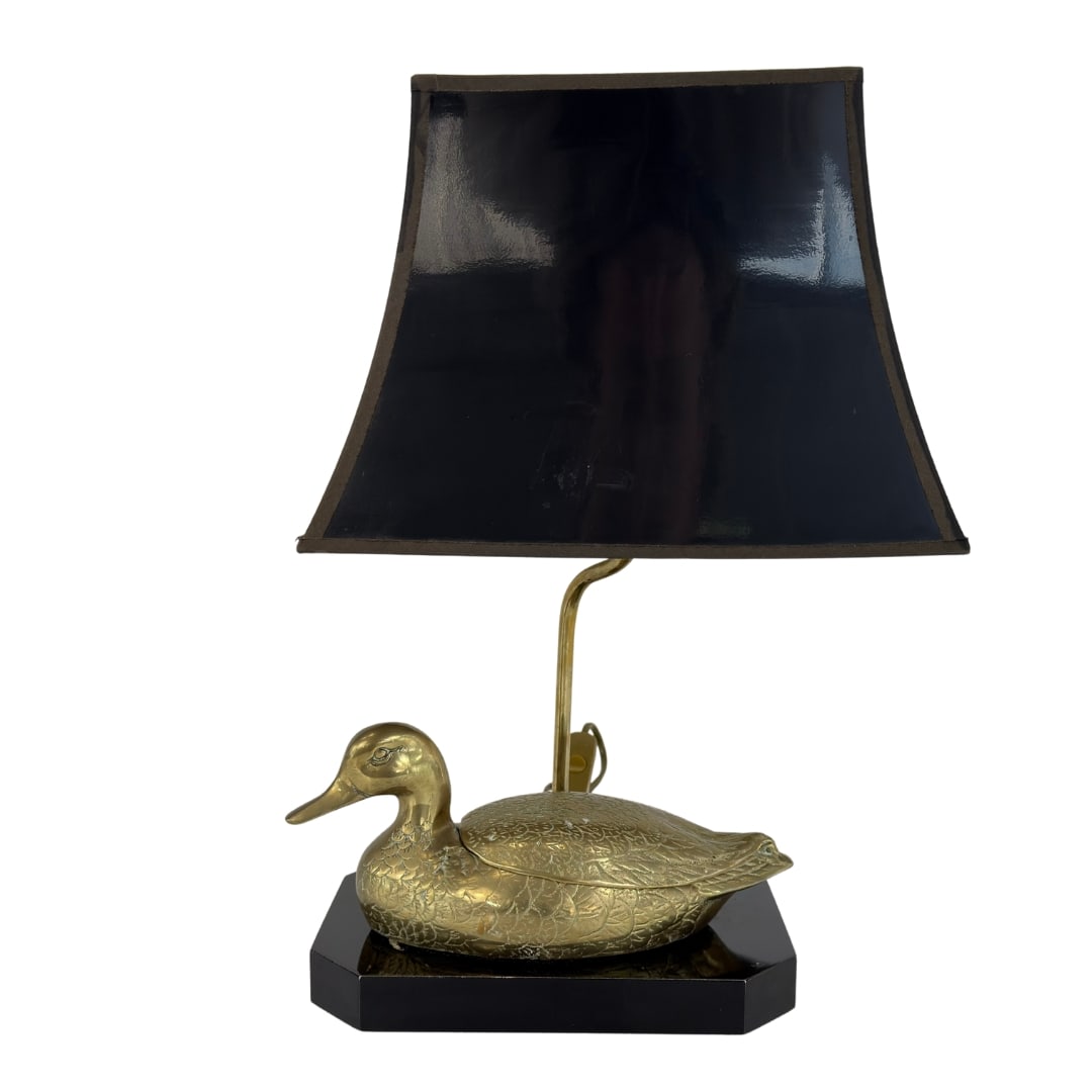 FRENCH BRASS DUCK LAMP ATTR. TO MAISON JENSEN: Dimensions: H 18.5” x W 9.7” x D 6.5”. French Hollywood Regency brass duck table lamp attr. to Maison Jensen with black lampshade, 1970s.