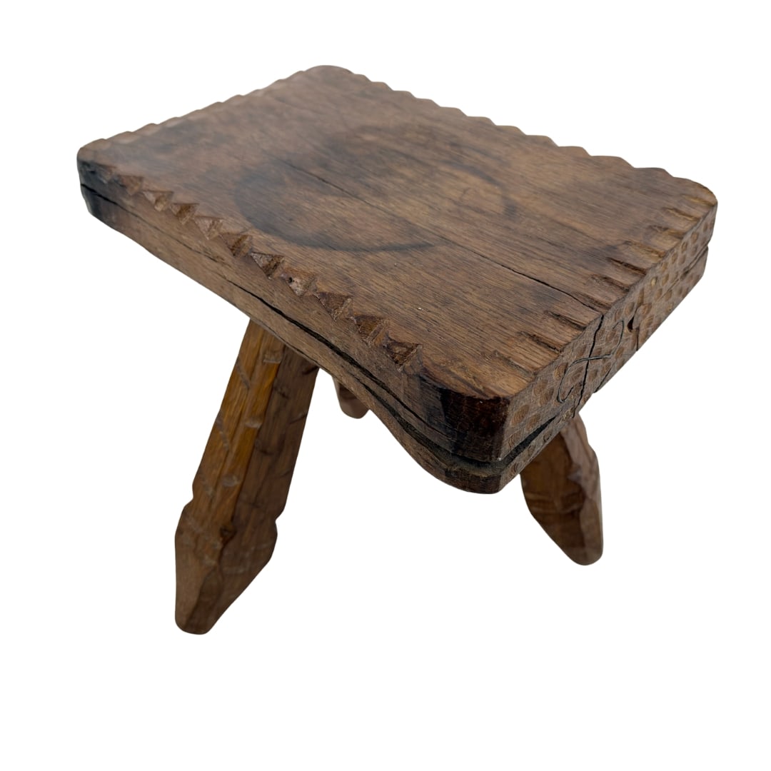BRUTALIST HAND-CARVED MILKING STOOL: Dimensions: H 12” x W 16” x D 10”. Vintage brutalist hand-carved wooden tripod milking stool.