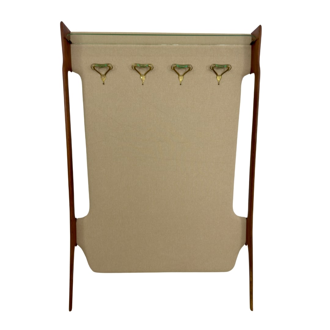 ITALIAN TEAK COAT HANGER: Dimensions: H 71.5” x W 47.5” x D 6.3". Vintage Italian wall coat hanger with glass shelf, 4 hooks and back covered in beige fabric.