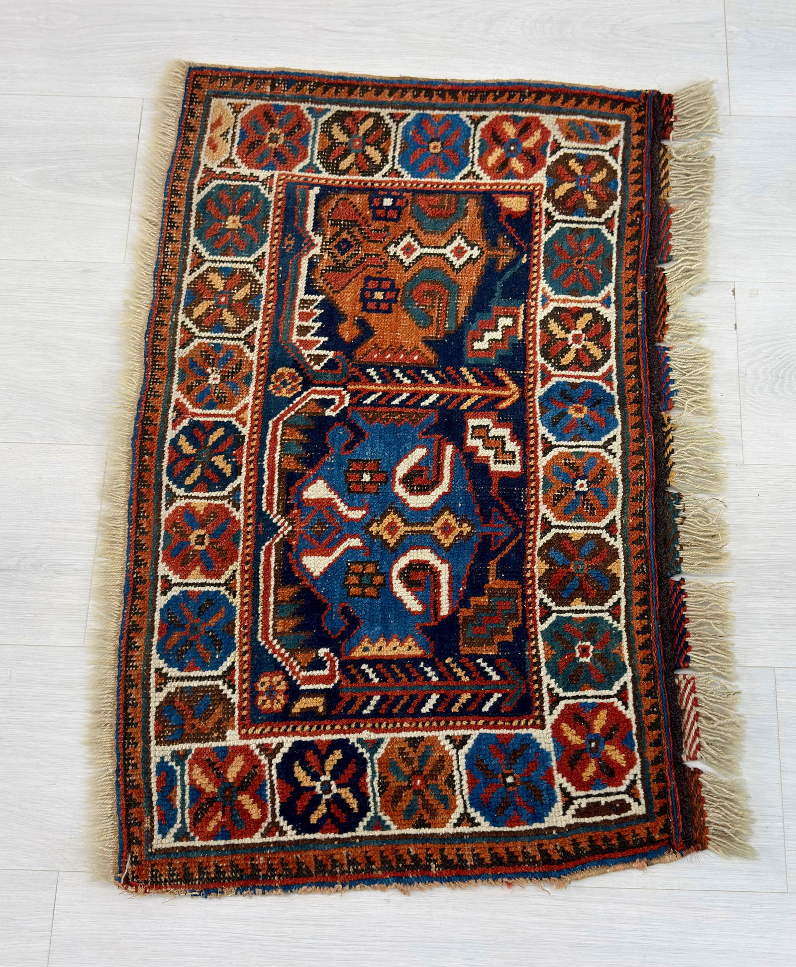 SEMIANTIQUE KAZAK WOOL RUG: Dimensions H 6'3" x W 2'6". Semiantique Kazak wool rug with geometric design.