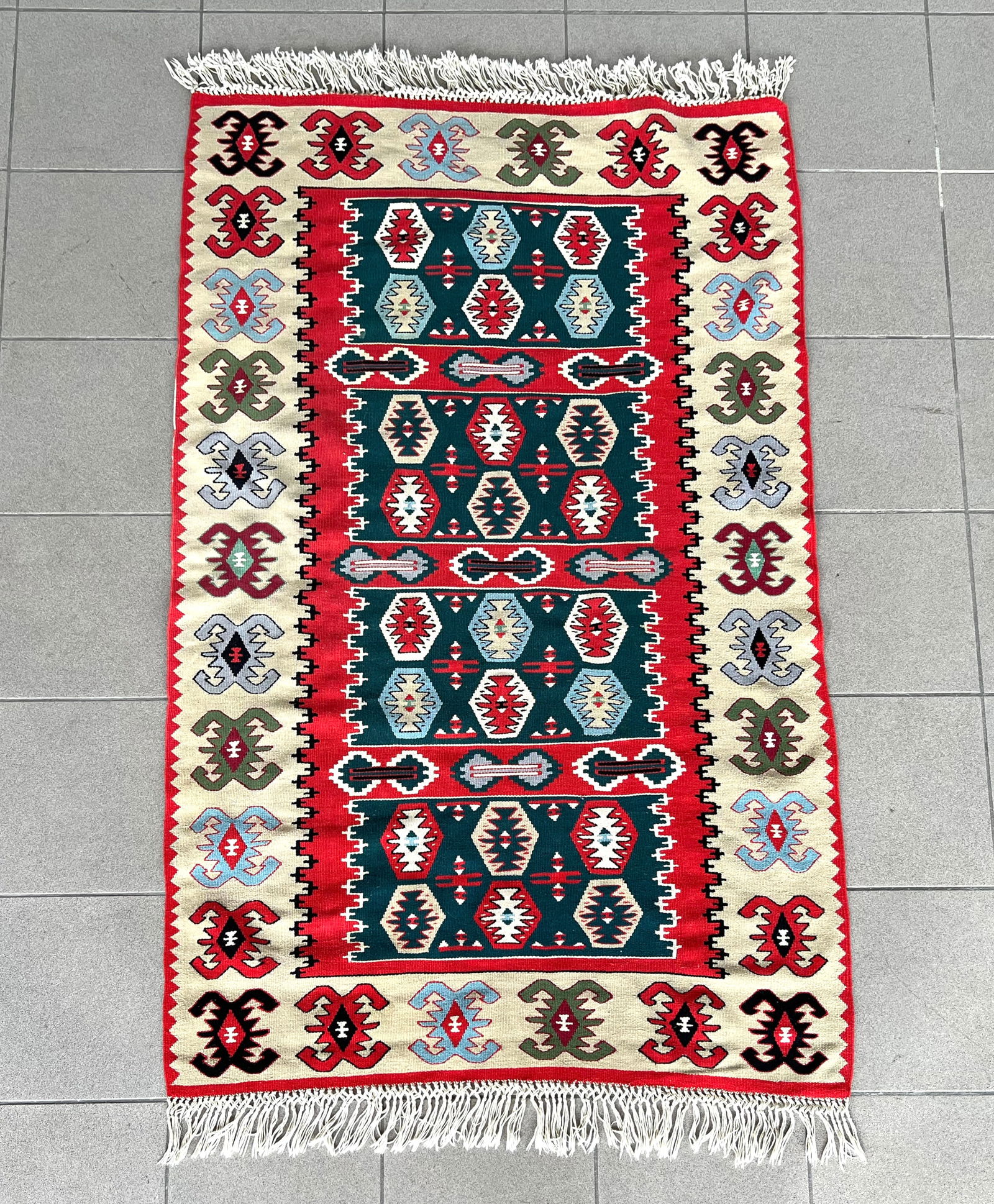SARKOY BULGARIAN FLATWEAVE KILIM RUG: Dimensions: H 5'6" x W 3'3". Hand knotted Sarkoy Bulgarian flatweave kilim rug with geometric pattern.