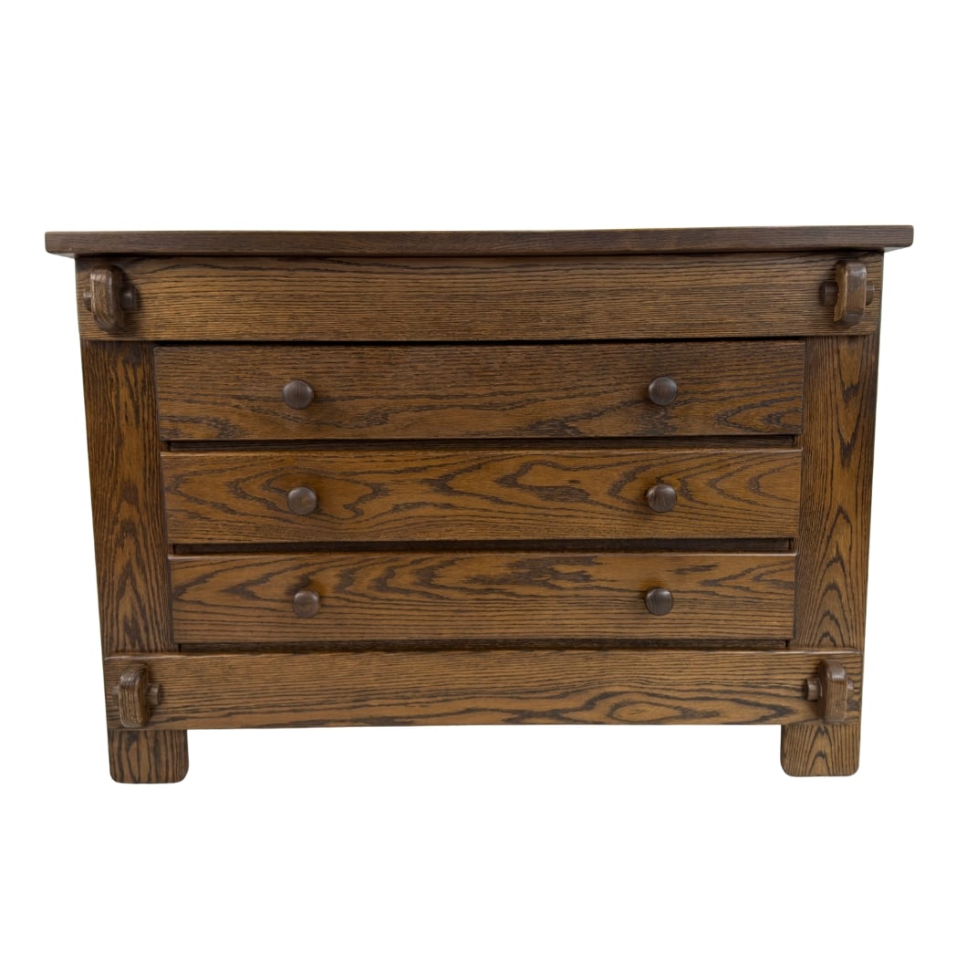 SPANISH BRUTALIST CHEST OF DRAWERS: Dimensions: H 33.5” x W 48” x D 20.7”. Spanish Brutalist oak chest of drawers with three drawers with wooden handles.