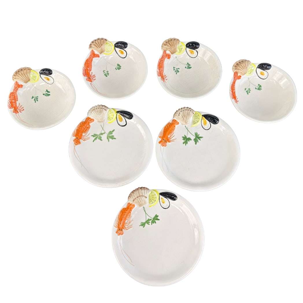 (7) VINTAGE MAJOLICA PLATES BY SIRO, 1980s: Dimensions: Diam. 10”. Set of 7 Vintage Italian hand painted Majolica seafood plates by Siro. Four of the platters are with diam. 8”.