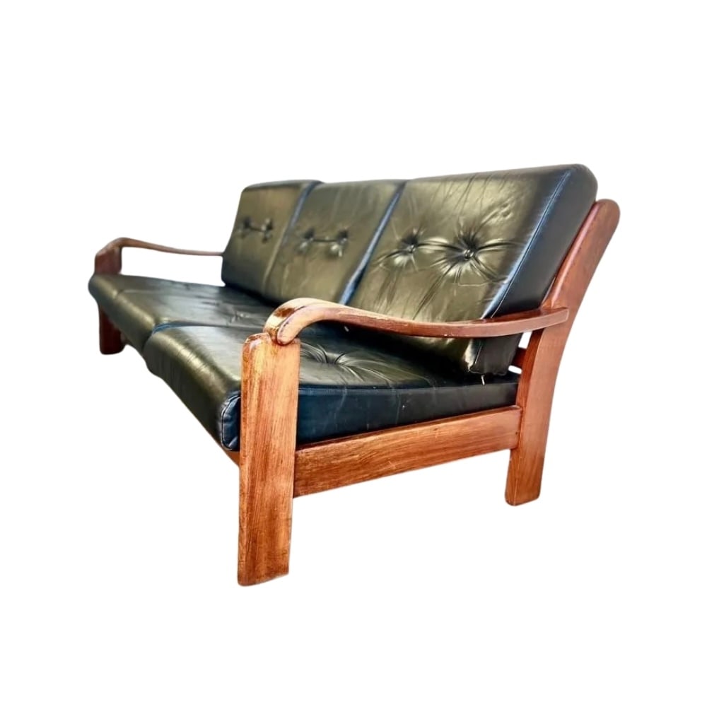 VINTAGE DANISH THREE-SEATER SOFA MANNER OF HOLSTEBRO: Dimensions: H 30.3” x W 79.9” x D 35”. Vintage Danish three-seater sofa manner of Holstebro with teak frame and original black faux leather loose padded cushions.