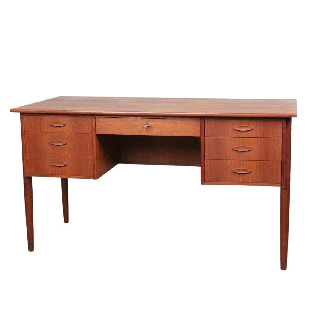 DANISH TEAK DESK, 1960s: Dimensions: H 29.3” x W 52.7” x D 25.3”. Vintage Danish teak desk with one central drawer with key and three drawers on both sides.