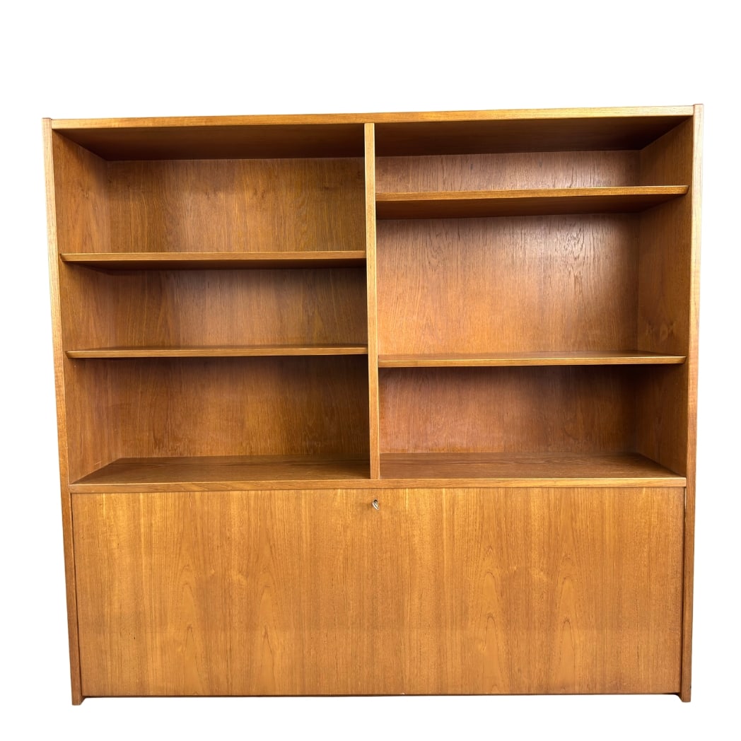 POUL HUNDEVAD TEAK BOOKCASE: Dimensions: H 51” x W 54.3” x D 12.2”. Danish teak secretary bookcase designed by Poul Hundevad in the 1960s with shelves and a flap door with one available key.