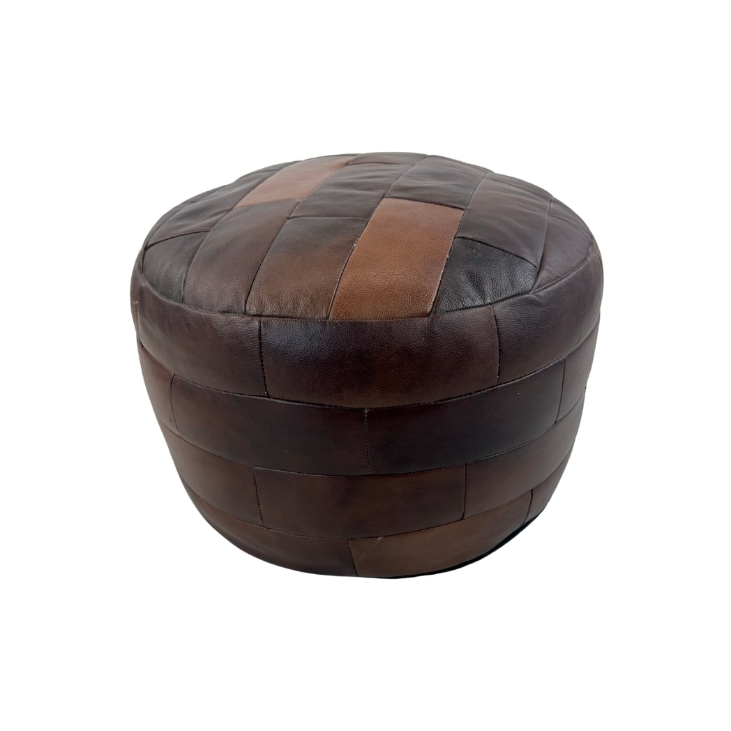 DE SEDE LEATHER POUF: Dimensions: H 15” x W 19”. Vintage brown leather patchwork pouf from De Sede.