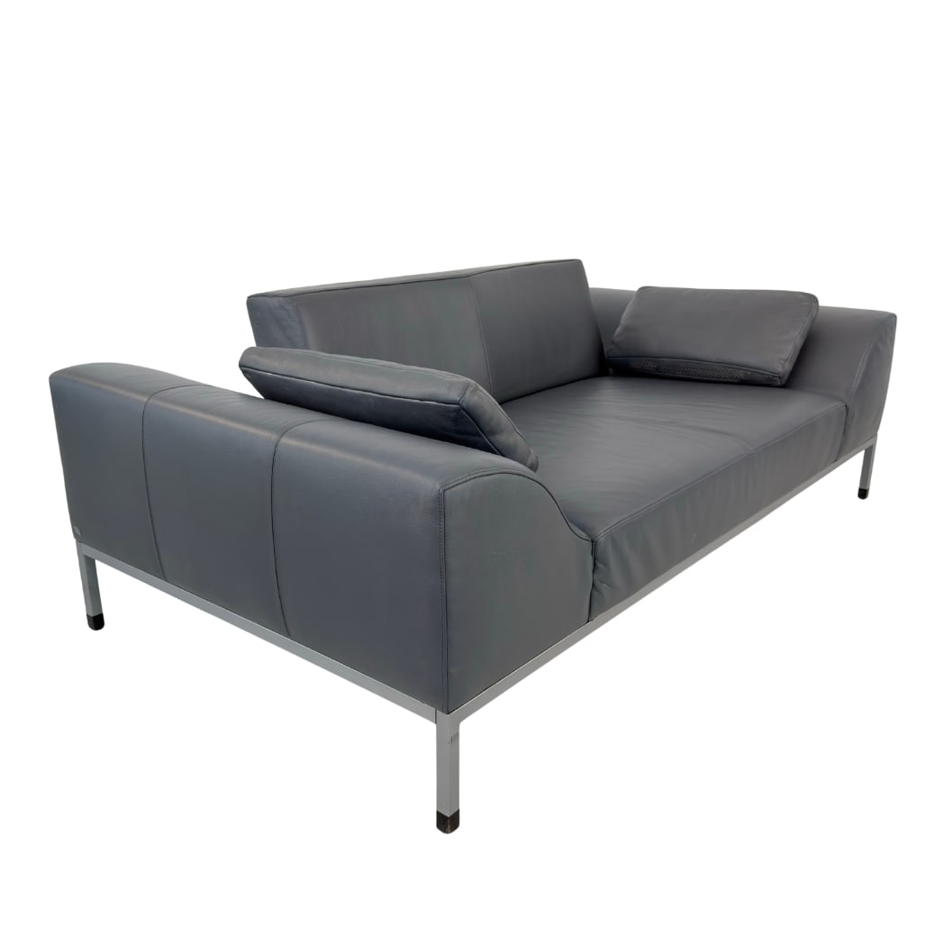 DE SEDE TWO-SEATER SOFA: Dimensions: H 27.5” x W 76” x D 41” x SH 15.5”. De Sede two-seater sofa in original grey leather with two pillows.