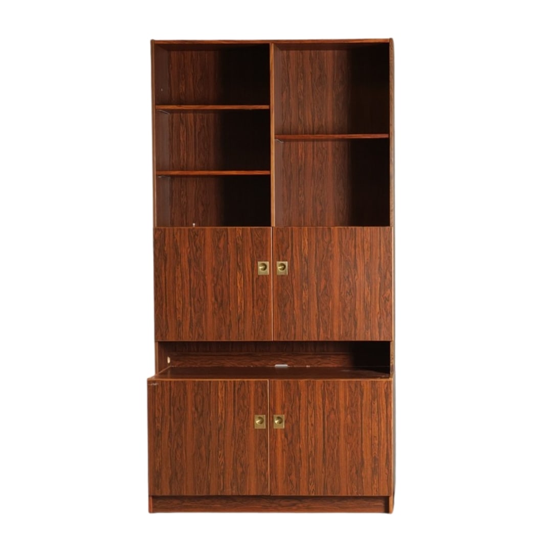 AEJM MOBLER ROSEWOOD SHELVING SYSTEM, 1970s: Dimensions: H 79.9” x W 40.9” x D 18.8”. Vintage Danish two-piece rosewood shelving system with brass handles, manufactured at AEJM Mobler in the 1960s.