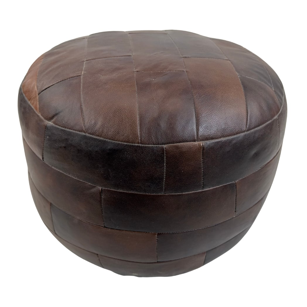 DE SEDE LEATHER POUF: Dimensions: H 15” x W 19”. Vintage De Sede brown leather patchwork pouf from the 1970s.