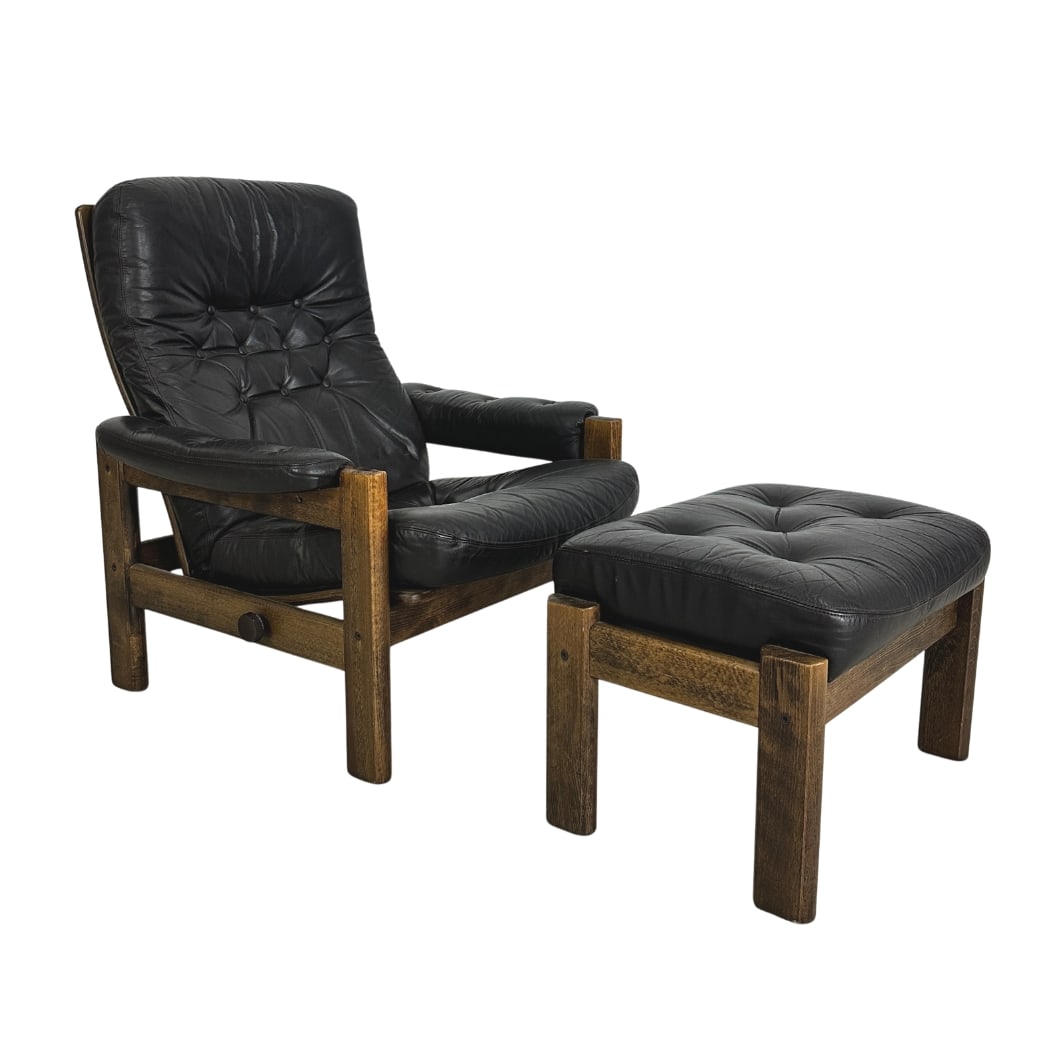 RECLINER ARMCHAIR WITH OTTOMAN MANNER OF PERCIVAL LAFER: Dimensions: H 36” x W 31.5” x SD 21” x SH 16”. Recliner armchair with ottoman in black leather with dark wood frame manner of Percival Lafer. Dimensions (ottoman) H 16”