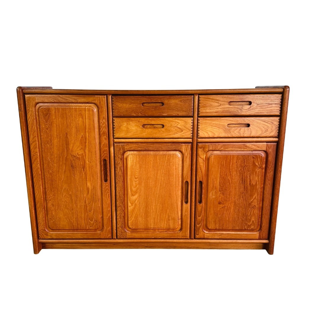 DYRLUND TEAK SIDEBOARD, 1960s: Dimensions: H 42” x W 62” x D 20”. Vintage Danish Dyrlund teak credenza sideboard with 4 small drawers and 3 cupboards with shelves inside.