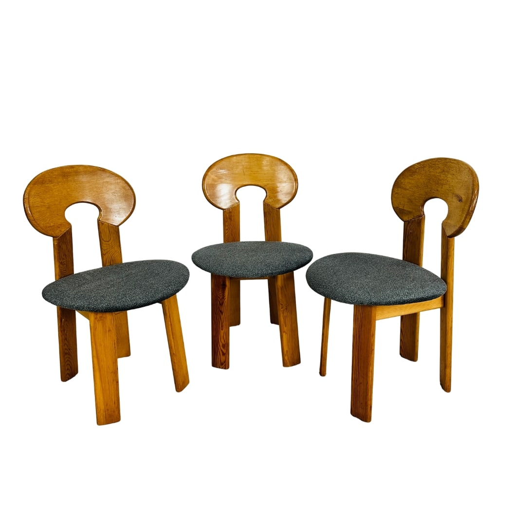 (3) BRUTALIST DINING CHAIRS MANNER OF CH990 EYELET CHAIR: Dimensions: H 32” x W 19.5” x SD 17.3” x SH 18.5”. Set of 3 Vintage pine dining chairs manner of CH990 Eyelet Chair with newly upholstered seats in dark grey fabric.