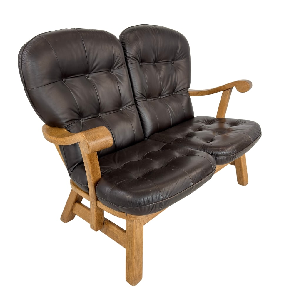 DANISH BRUTALIST SOFA: Dimensions: H 38” x W 49” x D 31” x SH 18”. Danish Brutalist dark-brown leather two-seater sofa with loose padded cushions.