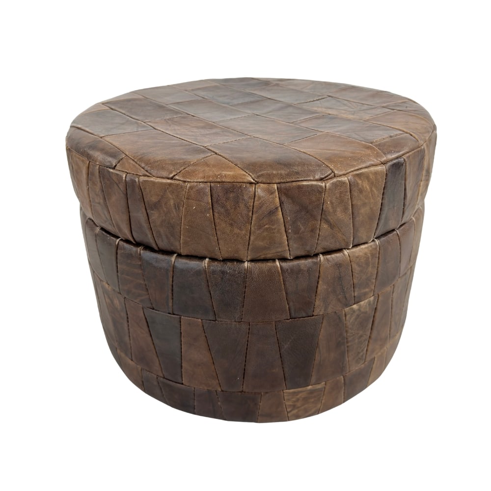 DE SEDE LEATHER POUF: Dimensions: H 13” x W 19.6". Vintage patchwork brown leather storage pouf from De Sede.