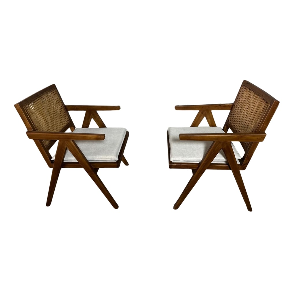 EASY LOUNGE CANE CHAIRS MANNER OF PIERRE JEANNERET, A PAIR: Dimensions: H 35.7” x W 24” x D 26.5” x SH 20.3”. Pair of easy lounge chairs manner of Pierre Jeanneret with cane backrest, teak frame and newly upholstered seats in light