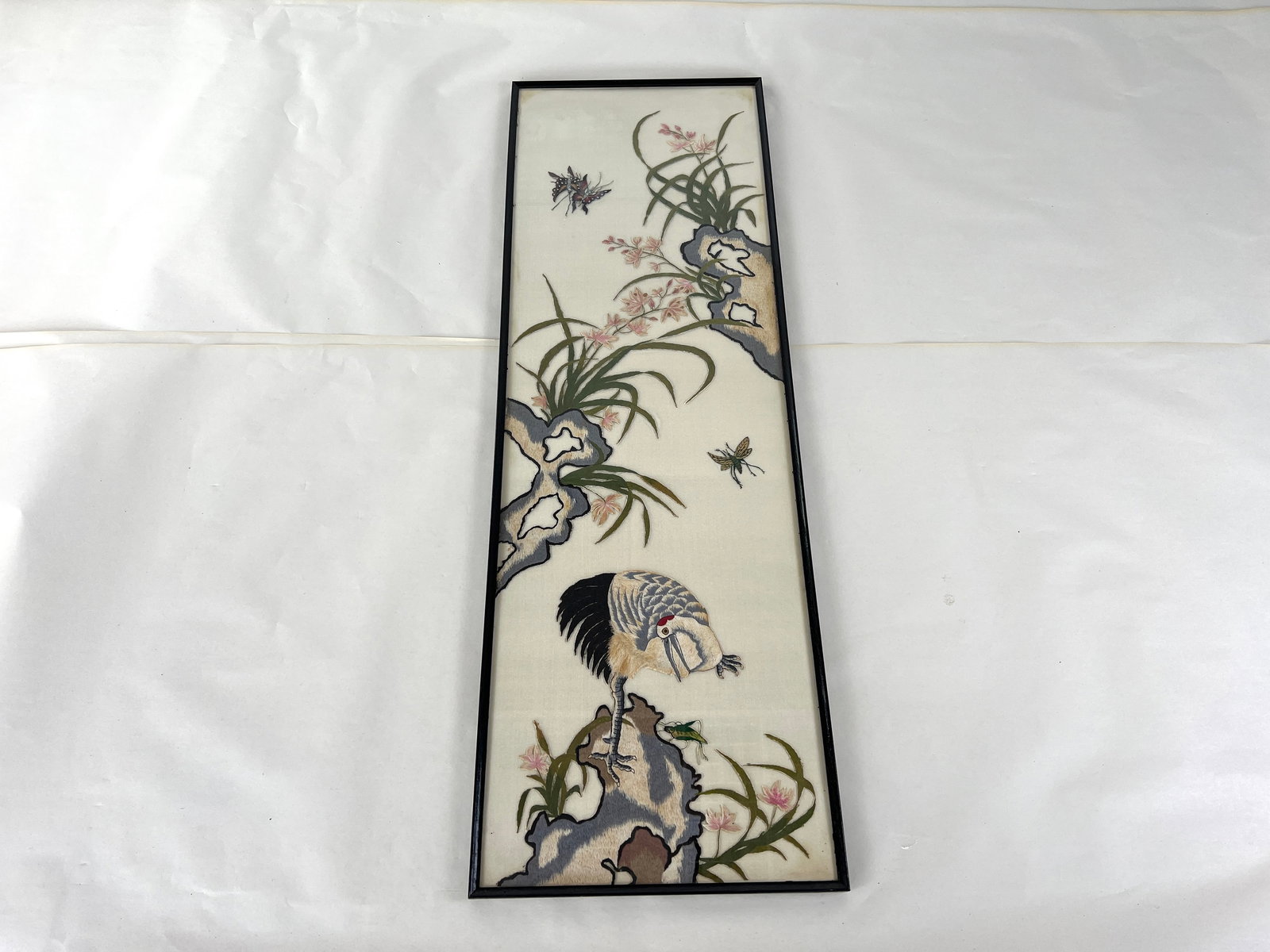 CHINESE SILK ART EMBROIDERY PAINTING: Dimensions: H 38.5” x W 12.7”. Antique Chinese framed floral textile art painting with glass on top.