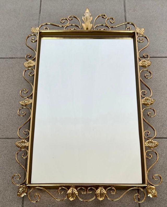 BRASS DEKNUDT MIRROR: Dimensions: H 25” x W 14.9” x D 1.2”. Vintage rectangular design mirror by Deknudt from 1960s on a brass frame, decorated with scrolls and foliage.