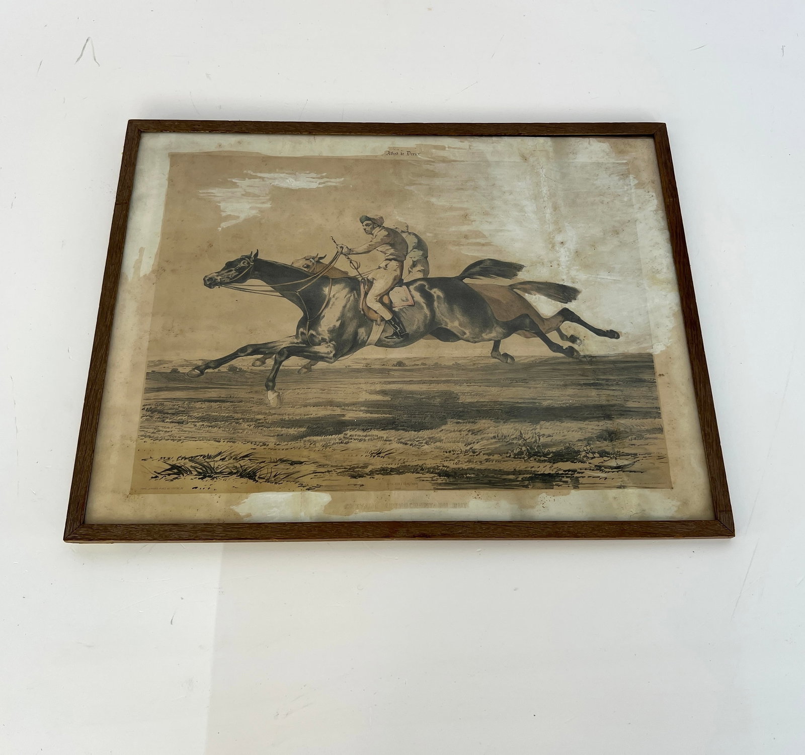 ALFRED DE DREUX LITHOGRAPH: Dimensions: H 18” x W 23.3”. Alfred De Dreux “Place du Louvre, 1920” framed lithograph.