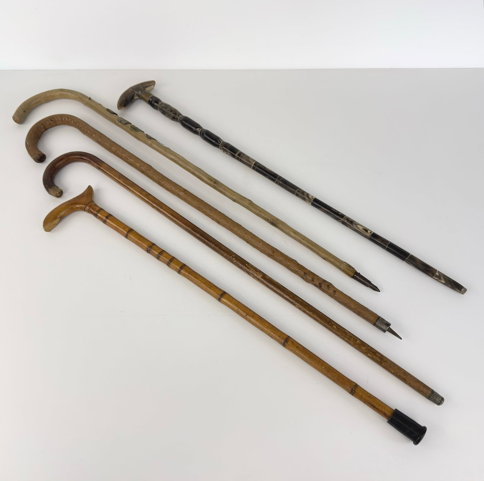 (5) VINTAGE WALKING STICKS: Dimensions: H 37”. Set of 5 Vintage hand-carved walking sticks.