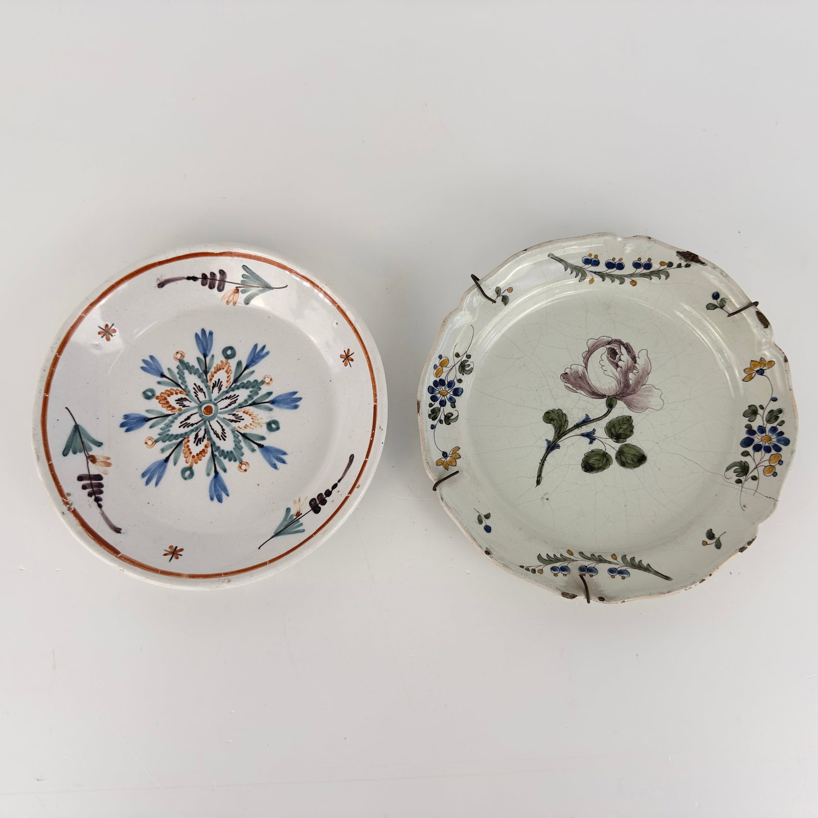 (2) CERAMIC DECORATIVE PLATES: Dimensions: W 9.3”. Set of 2 hand-painted ceramic decorative plates. Dimensions: W 9”.