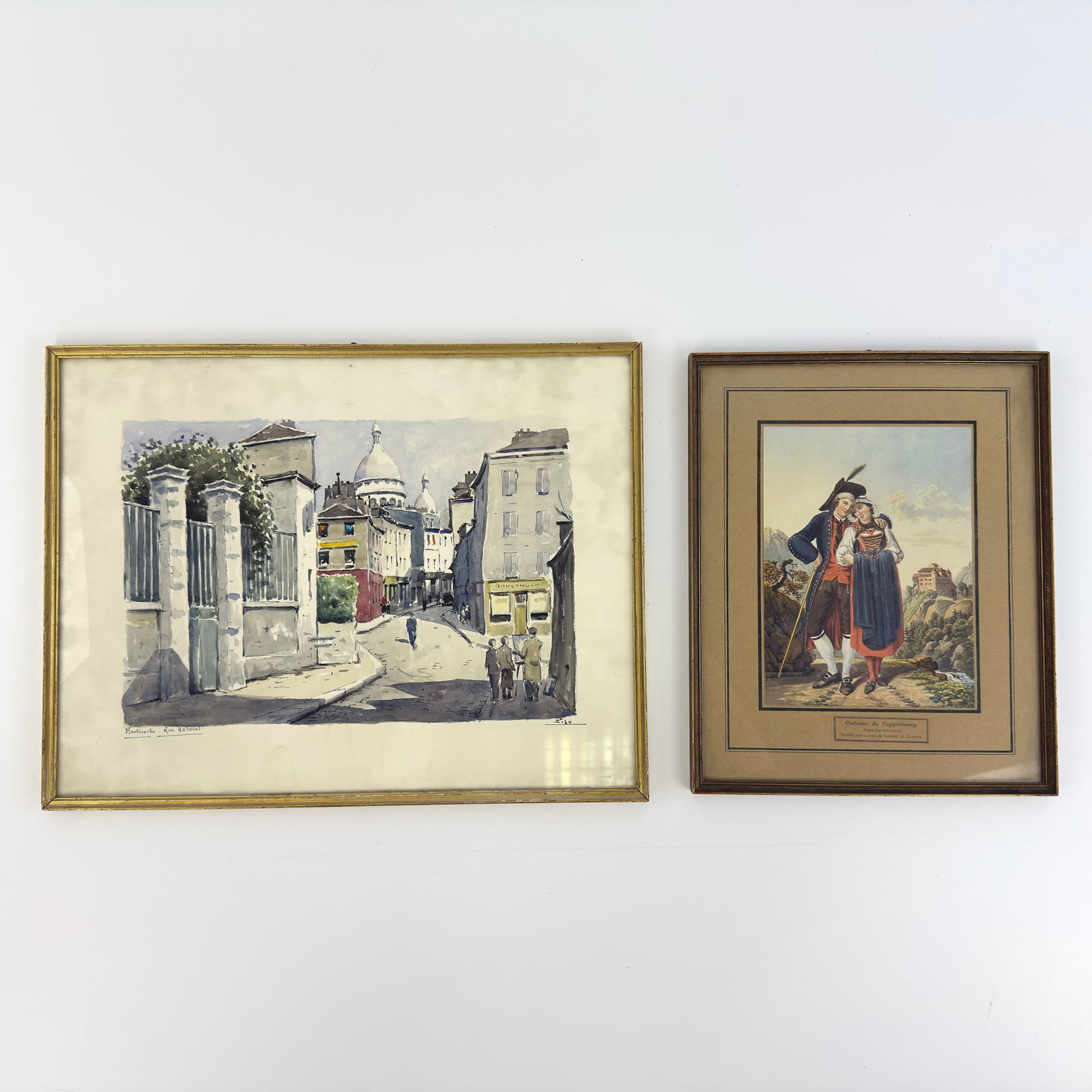 (2) VINTAGE FRAMED PAINTINGS: Dimensions: H 13.3” x W 17”. Set of 2 Vintage signed watercolor painting and “Costumes du Toggenbourg” artwork. Dimensions: H 13” x W 10.3”.