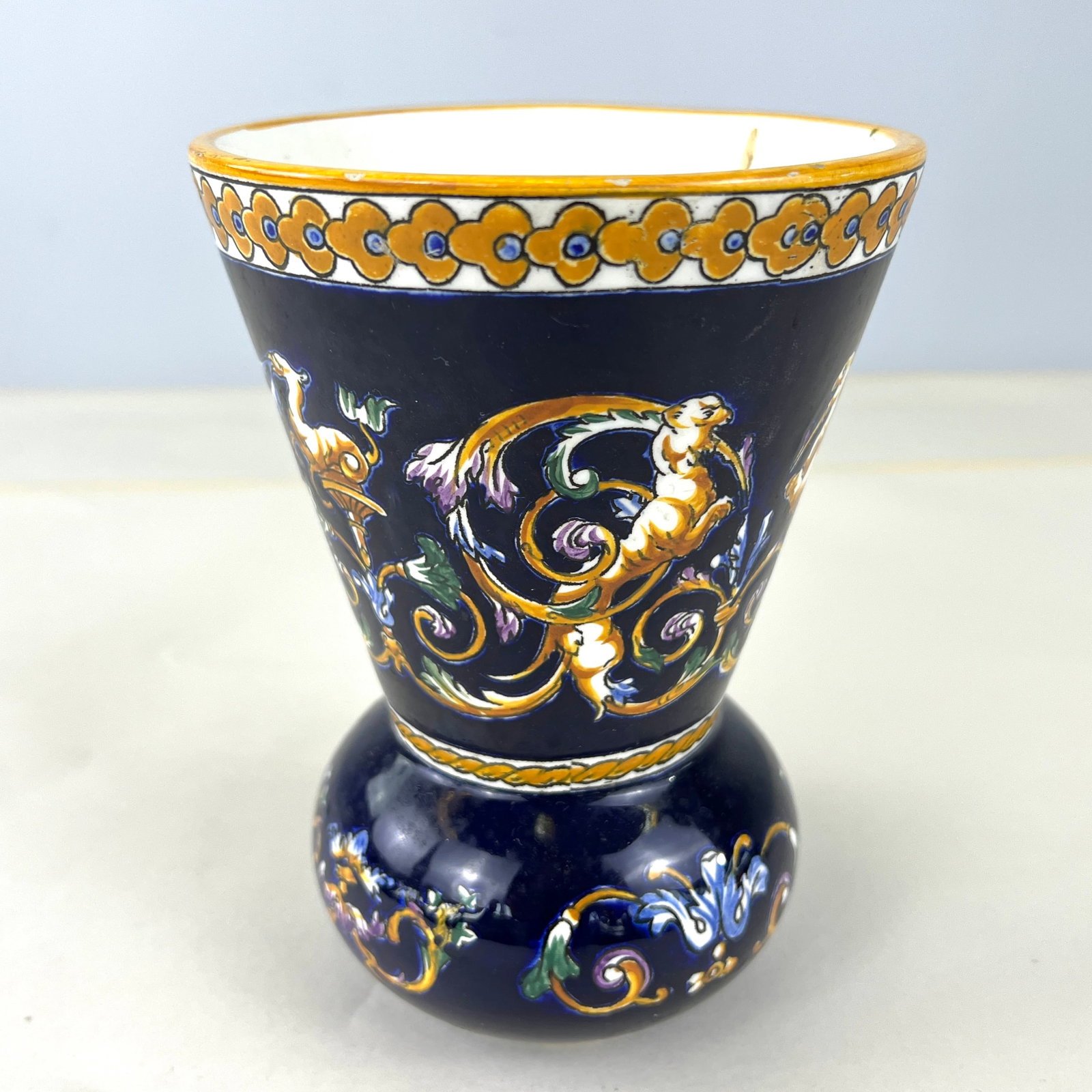 FRENCH GIEN HAND PAINTED VASE: Dimensions: H 6.7” x W 4.7”. French Gien hand painted porcelain vase with mythological faun scene. Marked on the bottom.