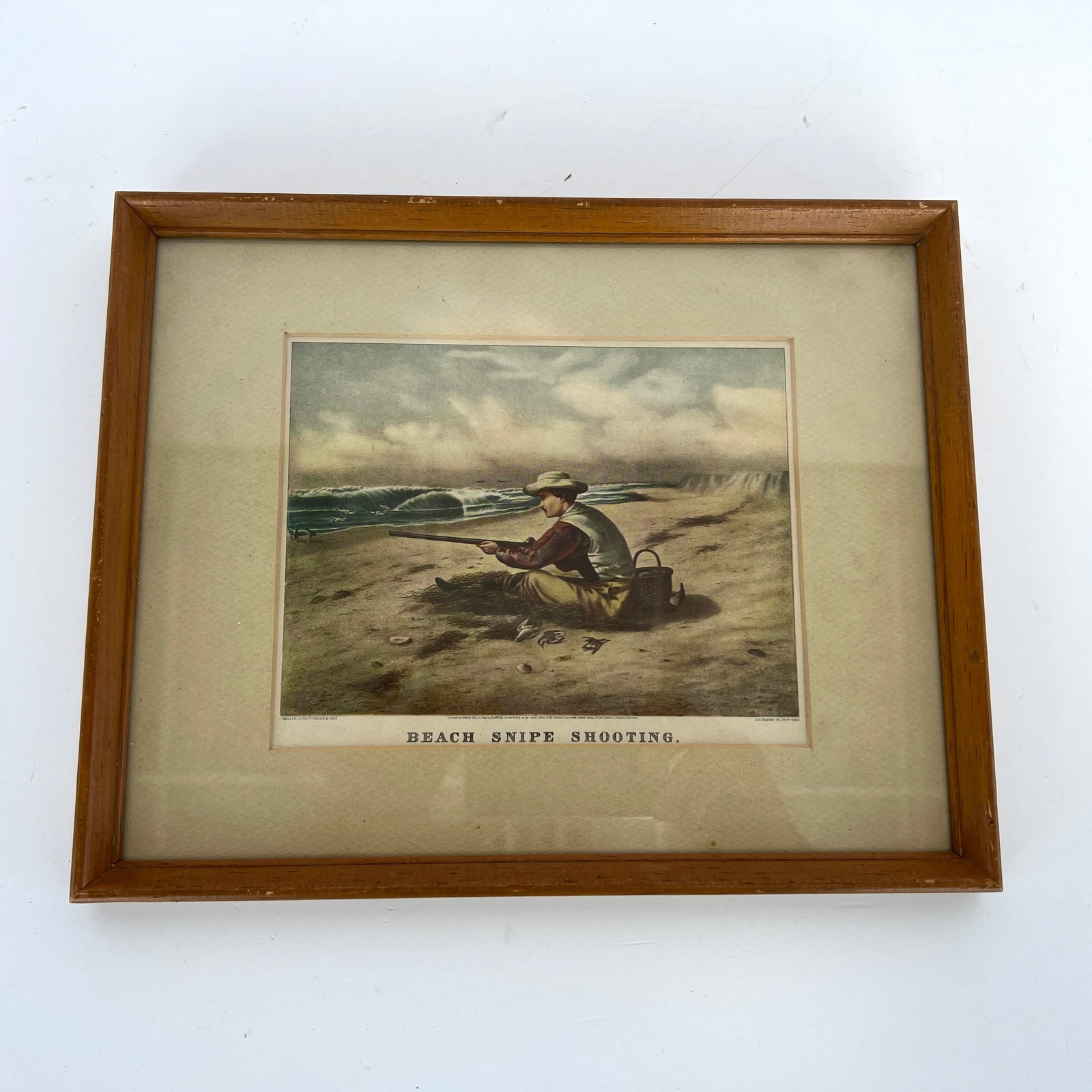 VINTAGE CURRIER & IVES ART PRINT BEACH SNIPE SHOOTING: Dimensions: H 10.3” x W 12.5”. Currier & Ives color art print “Beach snipe shooting” with wooden frame and glass on top.