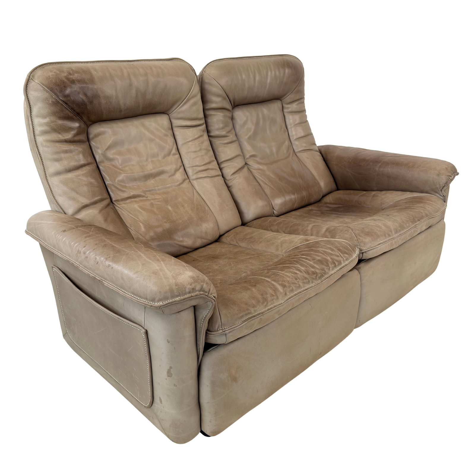 DE SEDE LEATHER TWO-SEATER SOFA: Dimensions: H 33” x W 59.5” x D 34” x SH 15”. Vintage De Sede brown leather two-seater sofa with magazine bag.