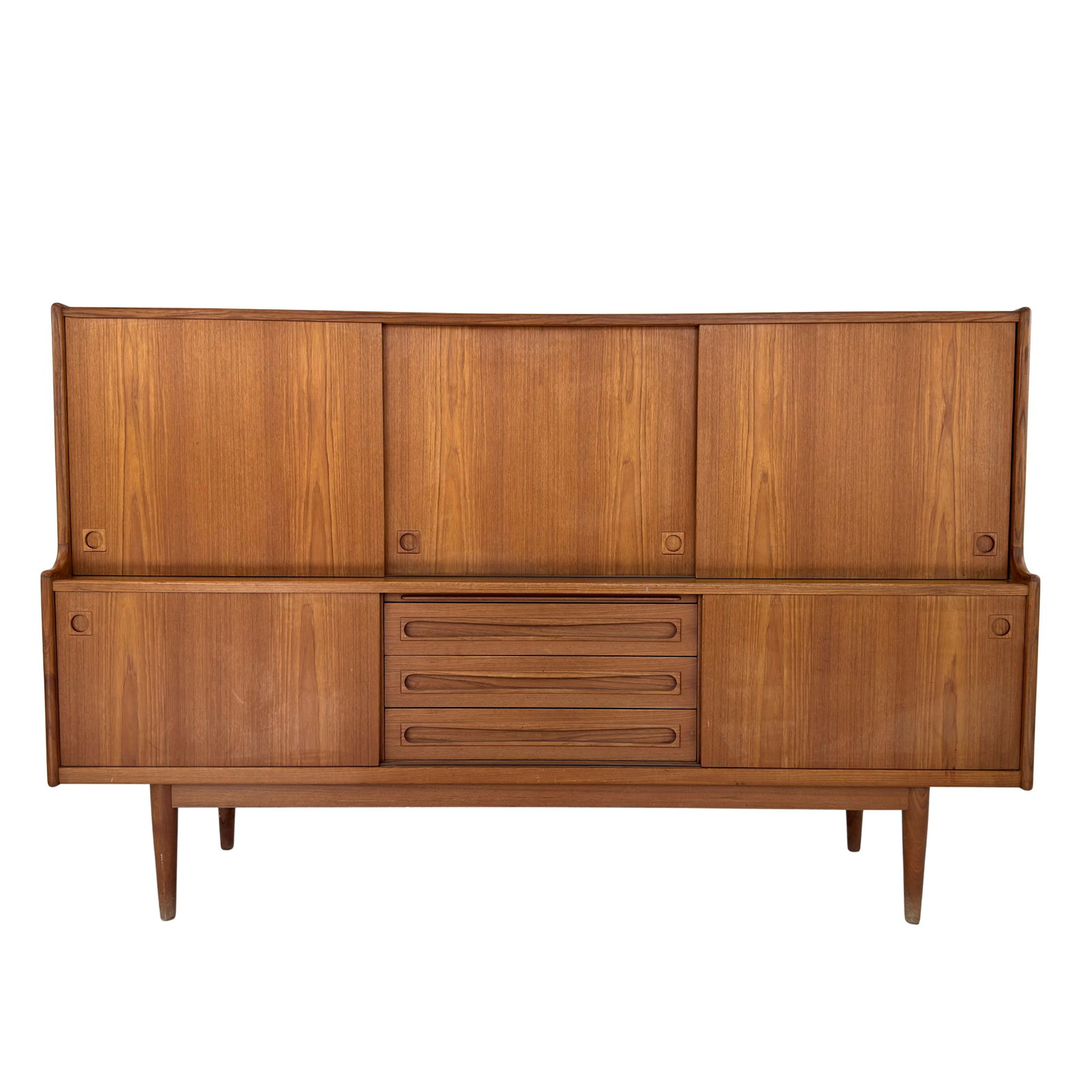 JOHANNES ANDERSEN SIDEBOARD, 1960s: Dimensions: H 51.5” x W 79” x D 19.6”. Danish teak sideboard designed by Johannes Andersen for Uldum Møbelfabrik with 3 central drawers and cupboards with sliding doors.