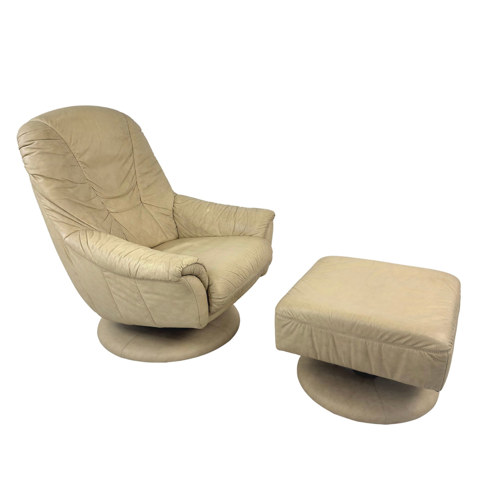 SWIVEL LEATHER ARMCHAIR WITH OTTOMAN MANNER OF EKORNES: Dimensions: H 39.5” x W 32.5” x D 37” x SH 17.7”. Scandinavian swivel beige leather lounge chair with swivel ottoman manner of Ekornes. Dimensions: (ottoman) H 16" x W 21.5" x 