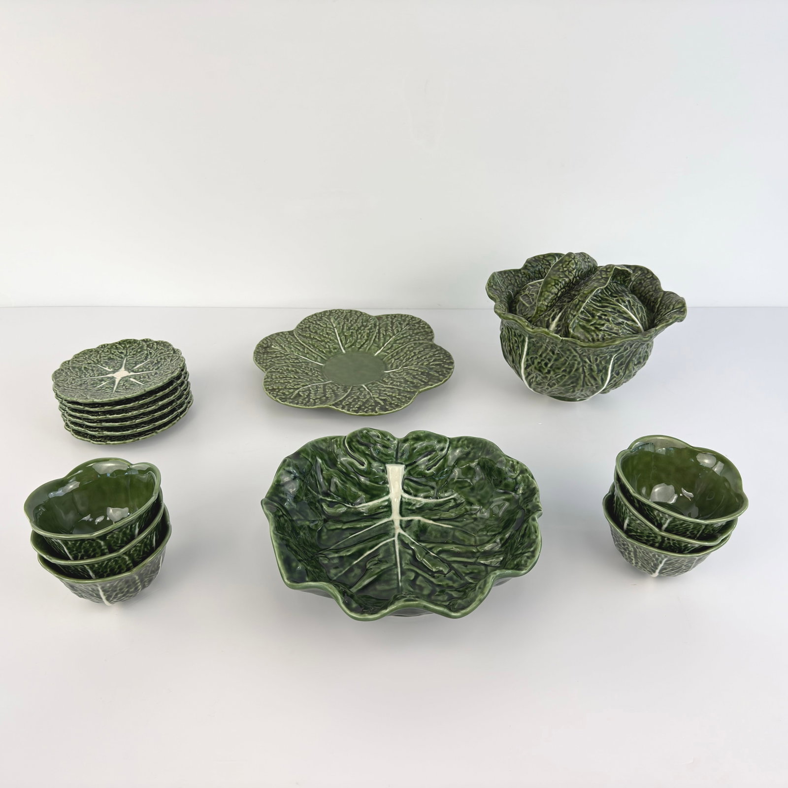 (15) PORTUGUESE MAJOLICA SET: Dimensions: H 9.3” x W 11.5”. Portuguese cabbage majolica set attr. to Bordallo Pinheiro, consist of 1 tureen, 6 bowls, 2 serving plates and 6 small plates. Dimensions: (bowls) H 3" x W