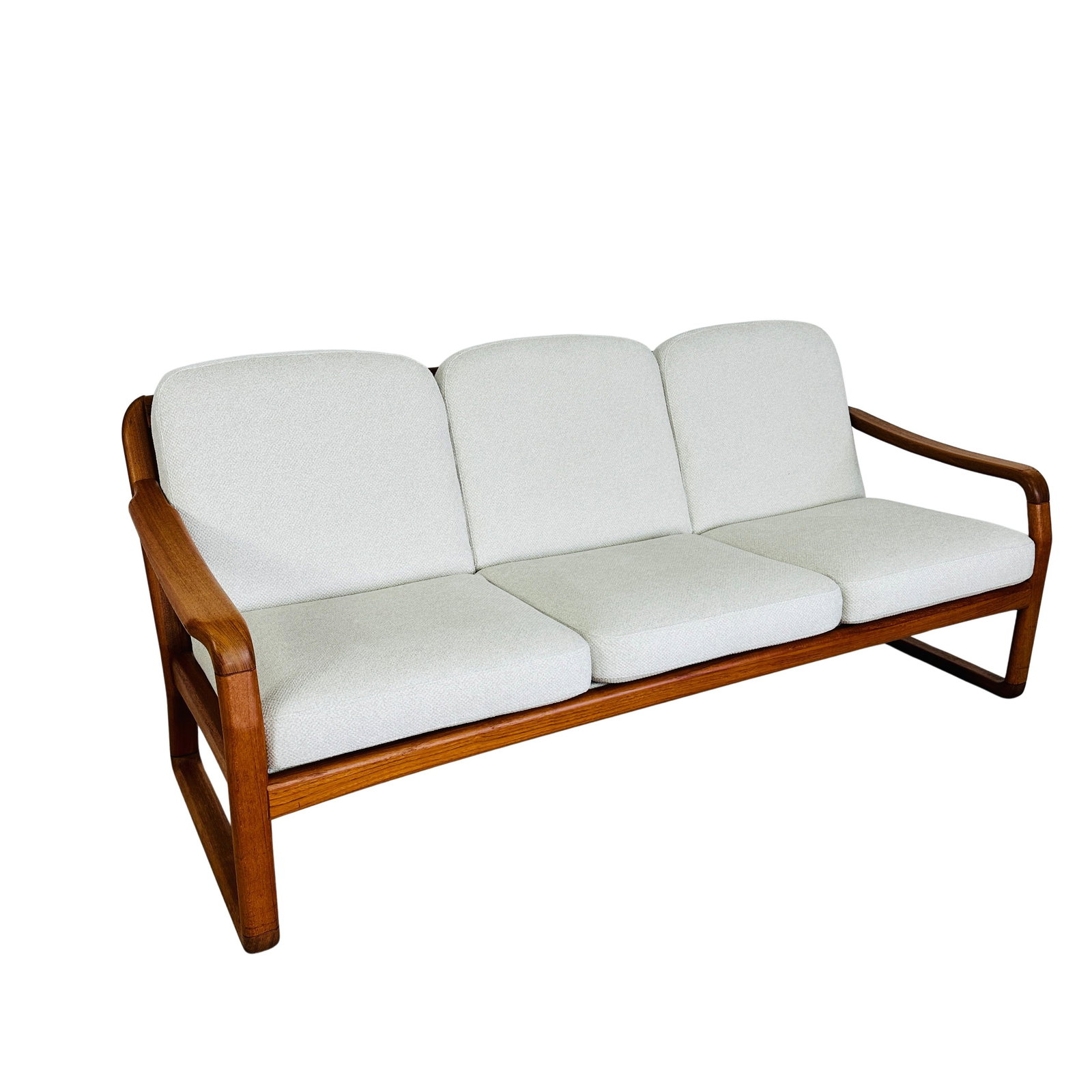 DANISH THREE-SEATER SOFA ATTR. TO HOLSTEBRO: Dimensions: H 31” x W 73.5” x D 28.5” x SH 17”. Danish teak three-seater sofa attr. to Holstebro, newly upholstered in off-white fabric.