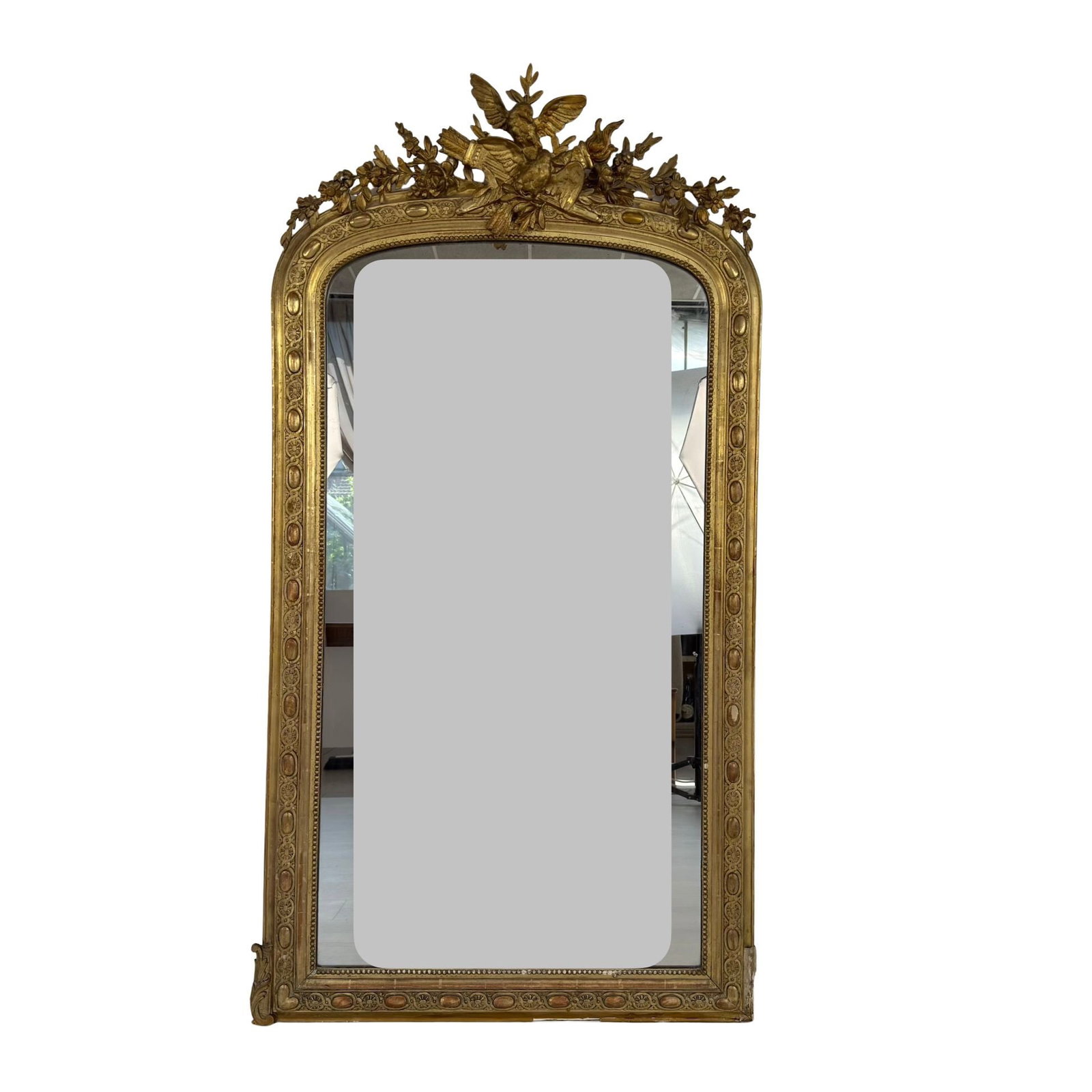 LOUIS PHILIPPE WALL MIRROR: Dimensions: H 64.5” x W 34”. Antique French Louis Philippe style ornate gilded wood wall mirror.