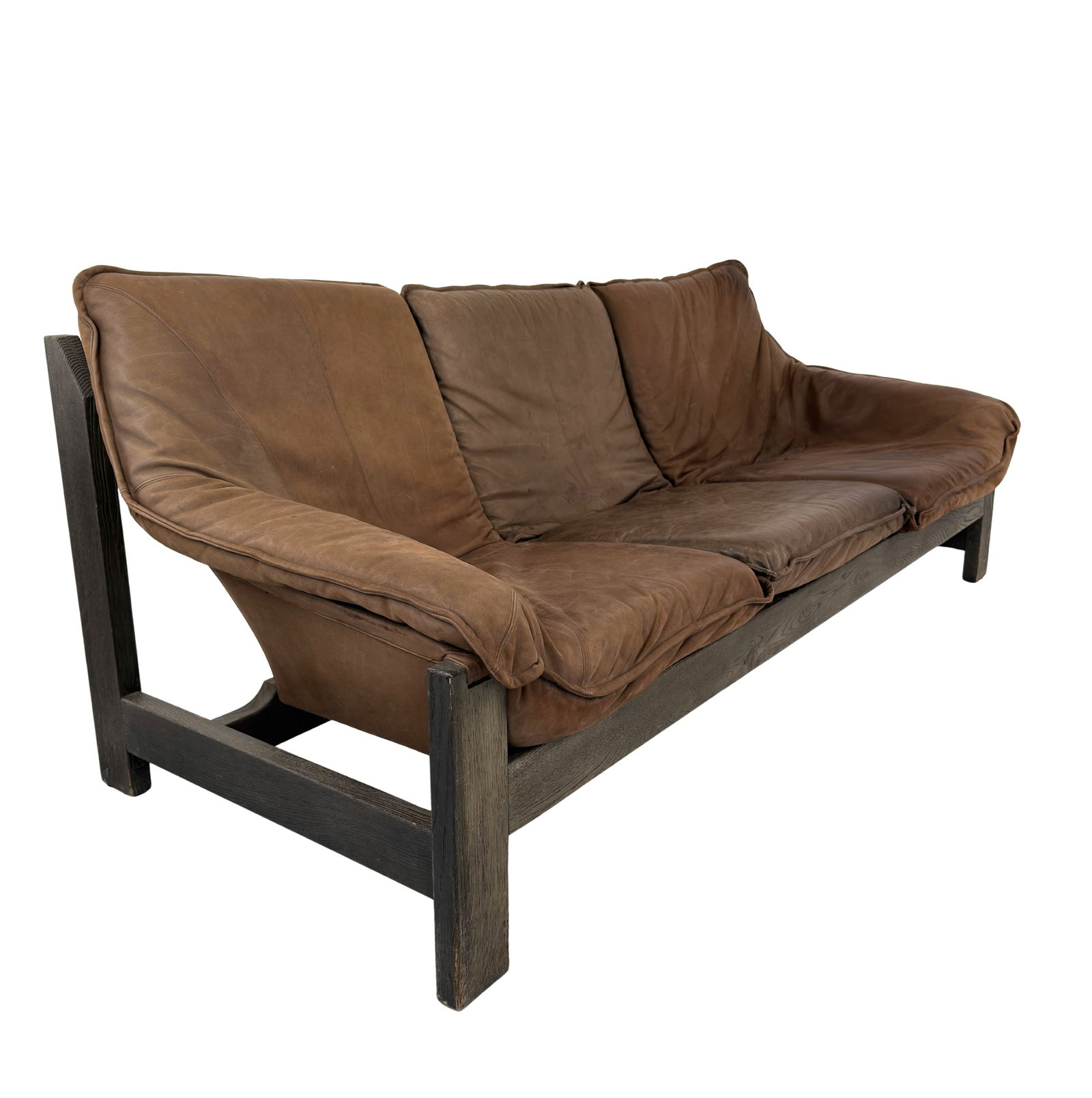THREE-SEATER SOFA MANNER OF MAISON REGAIN: Dimensions: H 31.5” x W 83” x D 36.5” x SH 16". Vintage three-seater oak sofa manner of Maison Regain with brown leather loose padded cushions, 1970s.
