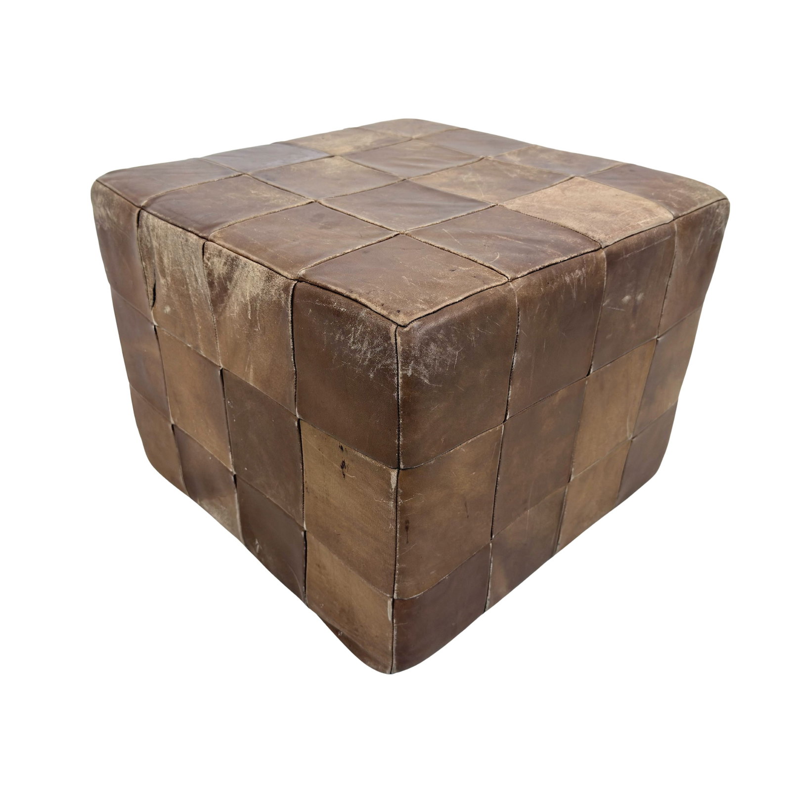 DE SEDE LEATHER POUF: Dimensions: H 15.5” x W 19.7” x D 19.7”. Vintage brown leather patchwork pouf from De Sede.