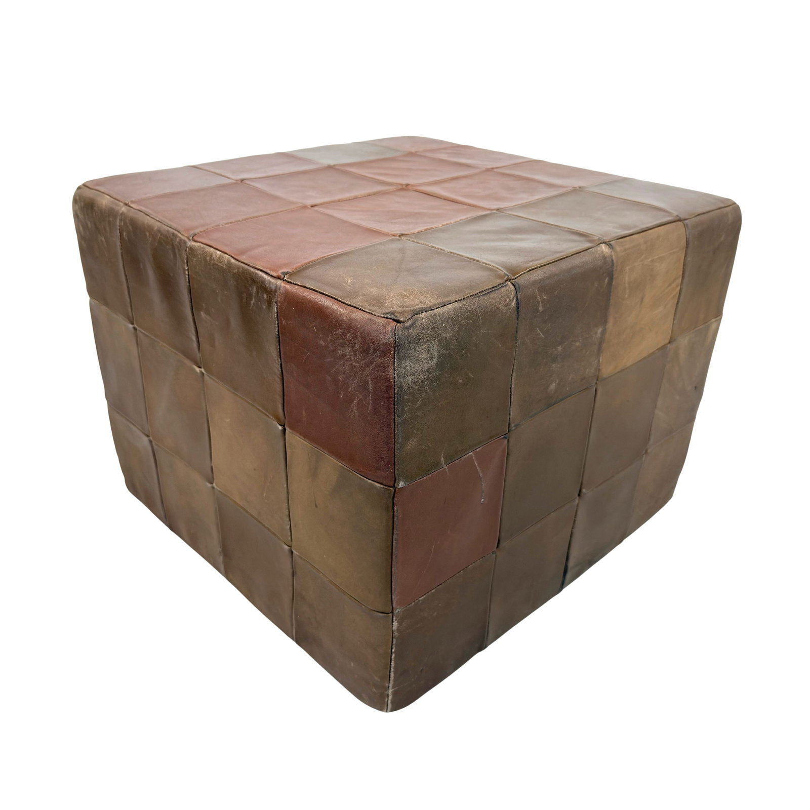 DE SEDE LEATHER POUF: Dimensions: H 15.5” x W 20.5” x D 20.5”. Vintage brown leather patchwork pouf from De Sede.
