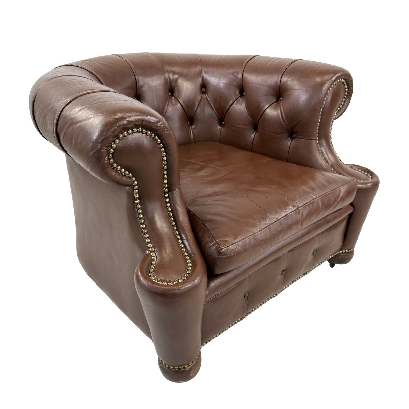 CHESTERFIELD CLUB CHAIR: Dimensions: H 29” x W 38” x D 37.5” x SH 17”. Vintage buttoned brown leather Chesterfield club armchair with loose padded cushion.