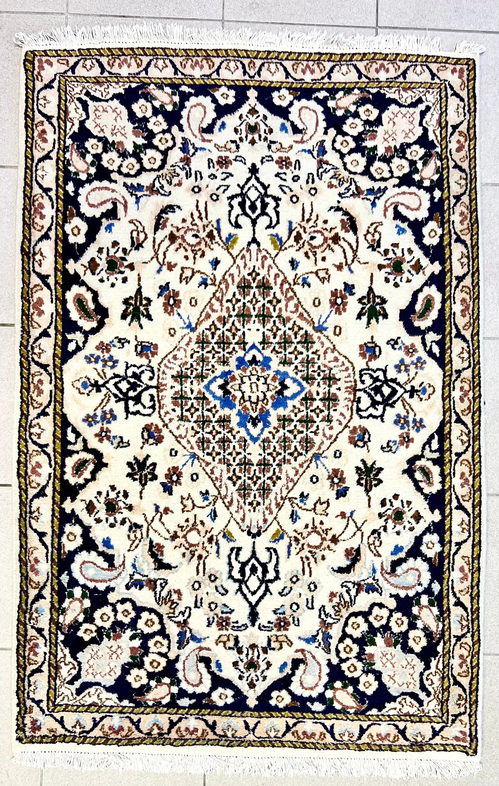 SMALL KIRMAN AREA RUG: Dimensions: H 4'6" x W 2'10". Small Persian Kirman area rug. Blue and white geometric design.