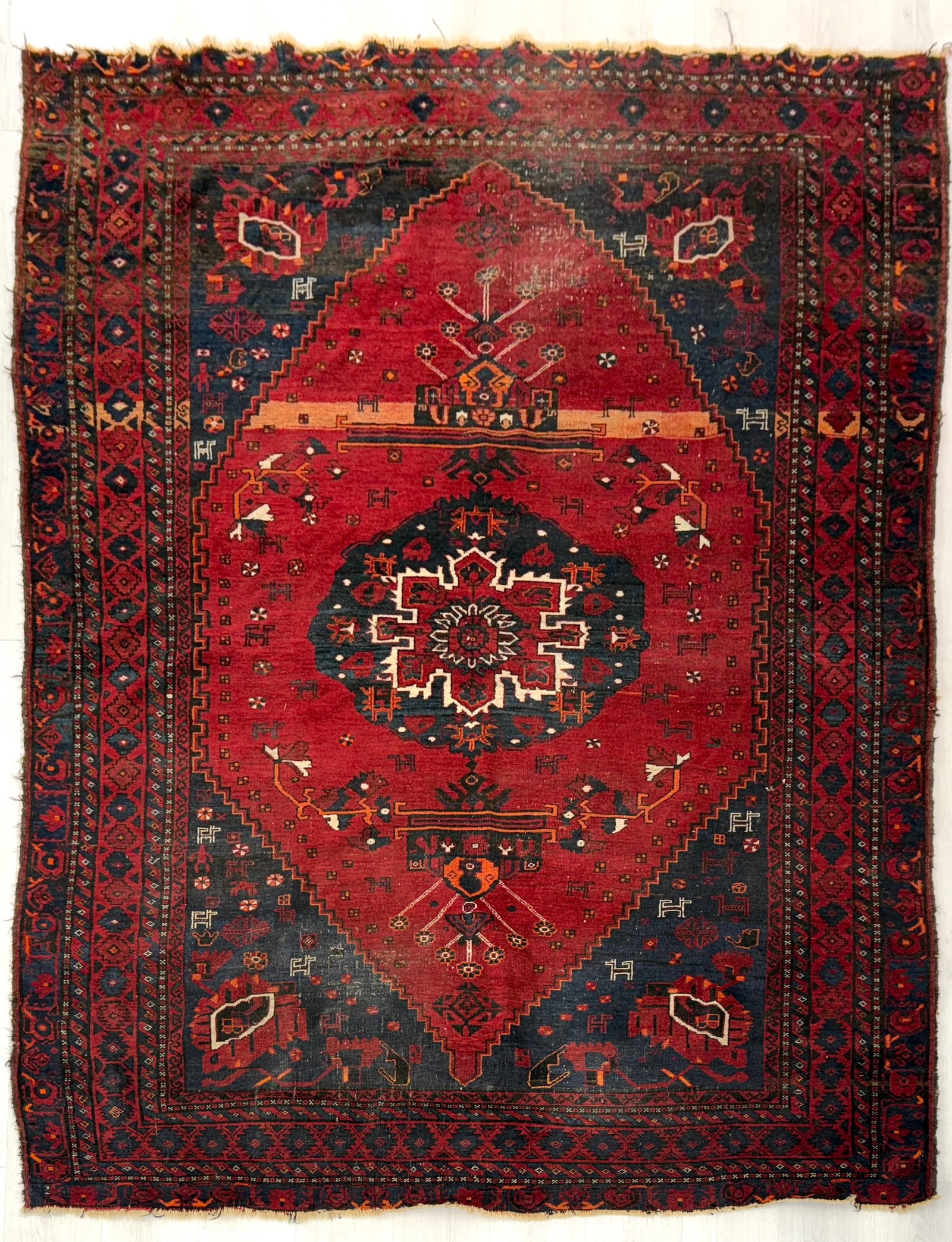HAND KNOTTED PERSIAN WOOL RUG: Dimensions: H 8'10" x W 6'3". Vintage hand-knotted Persian rug with geometric design, 1970s.