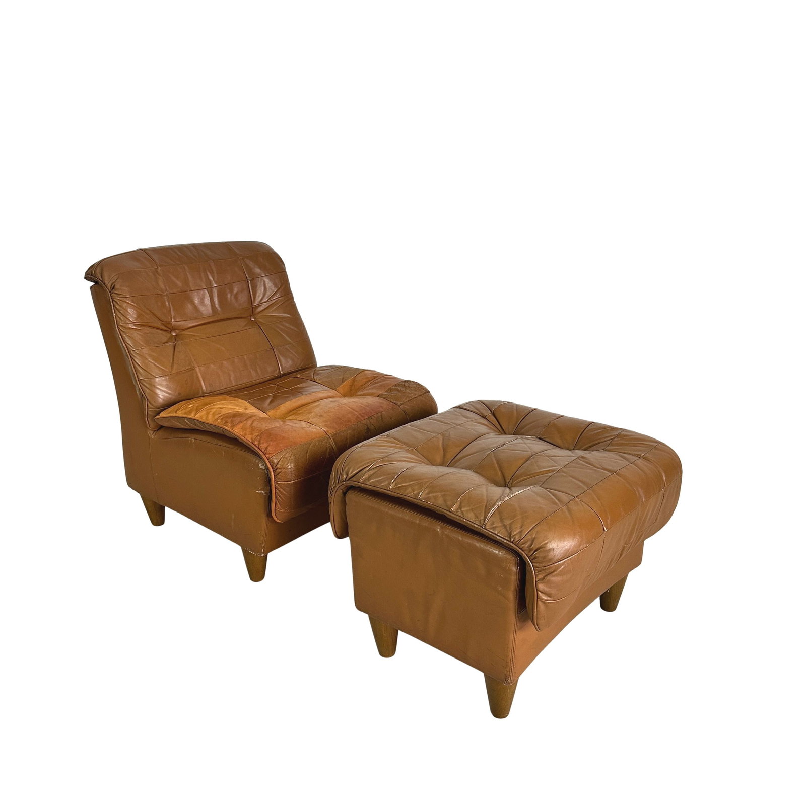ITALIAN LOUNGE CHAIR WITH OTTOMAN, 1970s: Dimensions: H 31” x W 25” x D 31” x SH 18.7”. Vintage Italian lounge chair with ottoman in cognac leather patchwork from the 1970s. Dimensions: (ottoman) H 20” x W